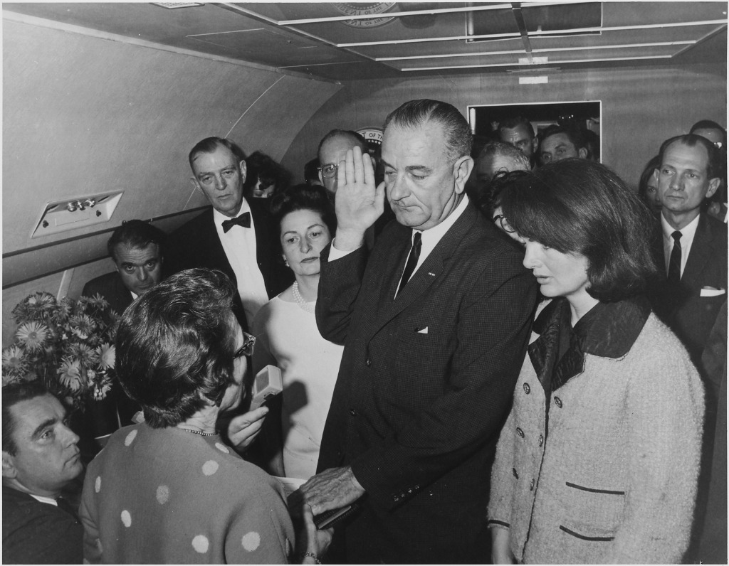 Lyndon B. Johnson being sworn in as President aboard Air Force One, with Jacqueline Kennedy at his side, November 22, 1963